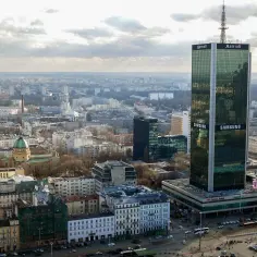 Widok na centrum Warszawy z wieżowcem Marriott i Samsungiem. W oddali widać inne budynki i zieleń.